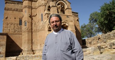 Tatoul Anoushian poses in front of a church in Van, eastern Turkey, Sept. 8, 2012. (AA Photo)