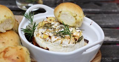 These rolls first bake together in the oven and are then pulled apart and paired up with some baked Camembert. (dpa Photo)  