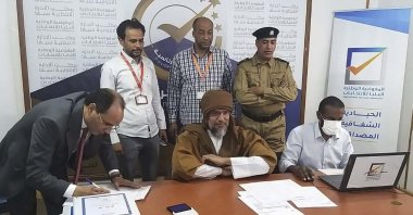 Seif al-Islam, center, the son and one-time heir apparent of late Libyan dictator Moammar Gadhafi registers his candidacy for the country’s presidential elections next month, in Sabha, Libya, Sunday, Nov. 14, 2021. (AP Photo)
