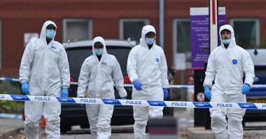Police forensics officers depart after working outside Liverpool Women's Hospital in Liverpool, Britain, Nov. 15, 2021. (AFP Photo)