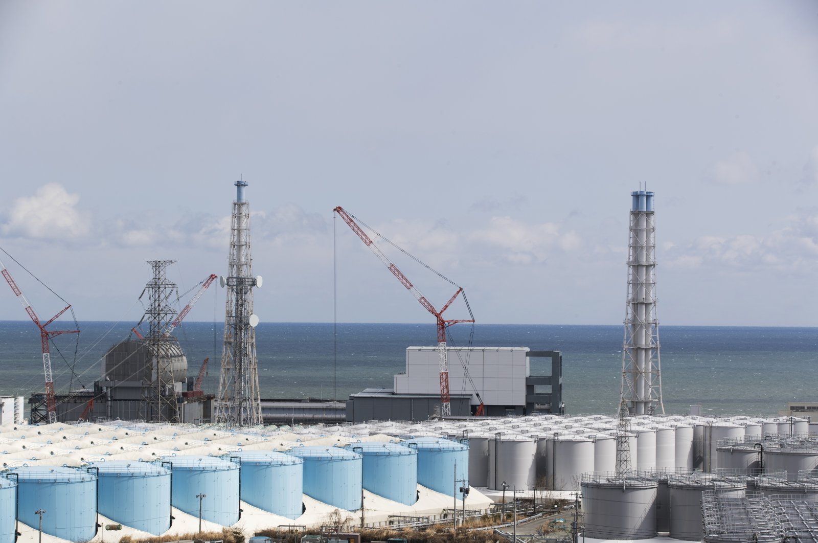 The Pacific Ocean looks over nuclear reactor units of No. 3 (L) and 4 at the Fukushima Daiichi nuclear power plant in Okuma town, Fukushima prefecture, northeastern Japan, Feb. 27, 2021. (AP Photo)