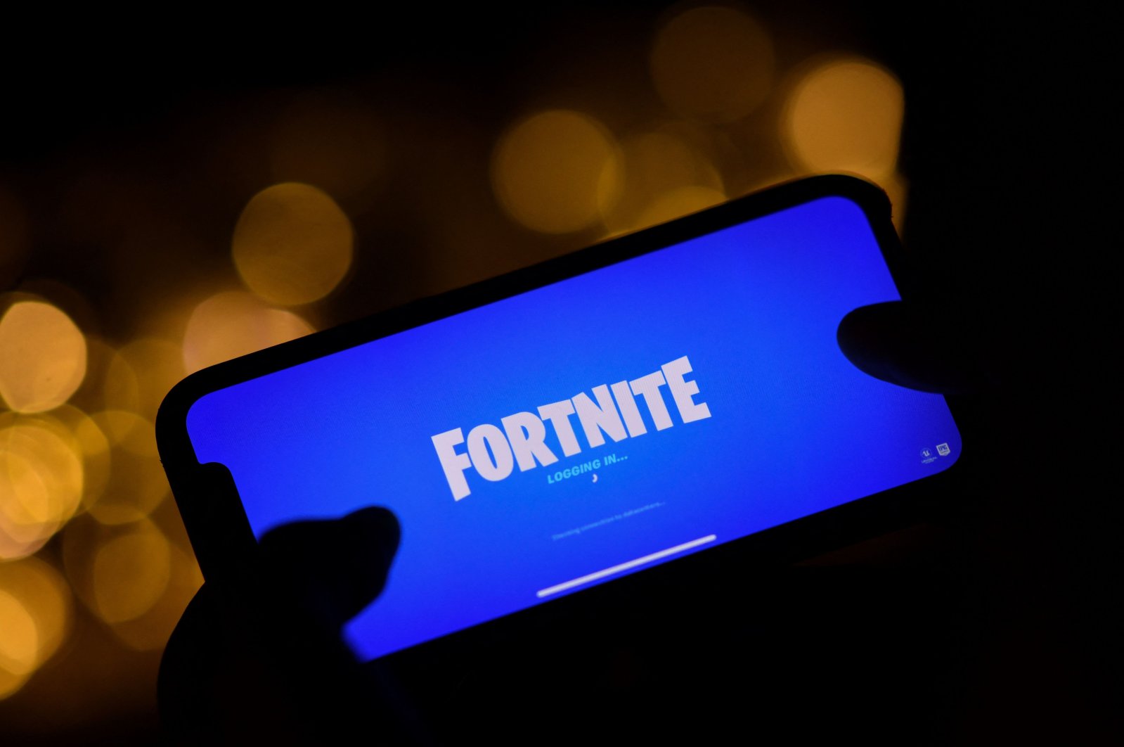This file illustration picture shows a person logging into Epic Games&#039; Fortnite on their smartphone in Los Angeles, U.S., Aug. 14, 2020  (AFP Photo)
