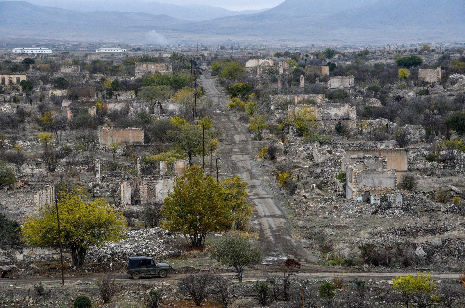 A car moves along a street of, deserted and ruined Karabakh city, Aghdam, Azerbaijan, November 19, 2020. (AFP Photo)