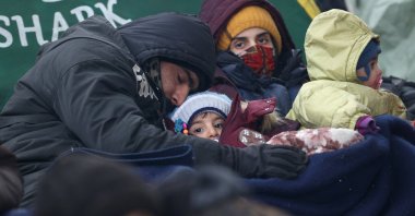 Migrants rest next to a tent set up at the Bruzgi-Kuznica Bialostocka border crossing in the Grodno Region, Belarus, Nov. 15, 2021. (Reuters Photo)