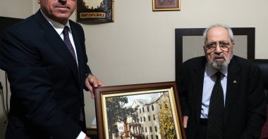 Author and poet Sezai Karakoç (R) receives a photograph from Kahramanmaraş Mayor Hayrettin Güngör, in Kahramanmaraş, southern Turkey. (AA Photo)