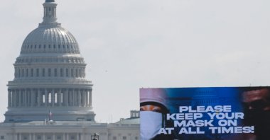 A sign advocating for mask wearing to protect against COVID-19 on the National Mall with the U.S. Capitol in the background is seen in Washington, D.C., Aug. 28, 2021. (AFP File Photo)