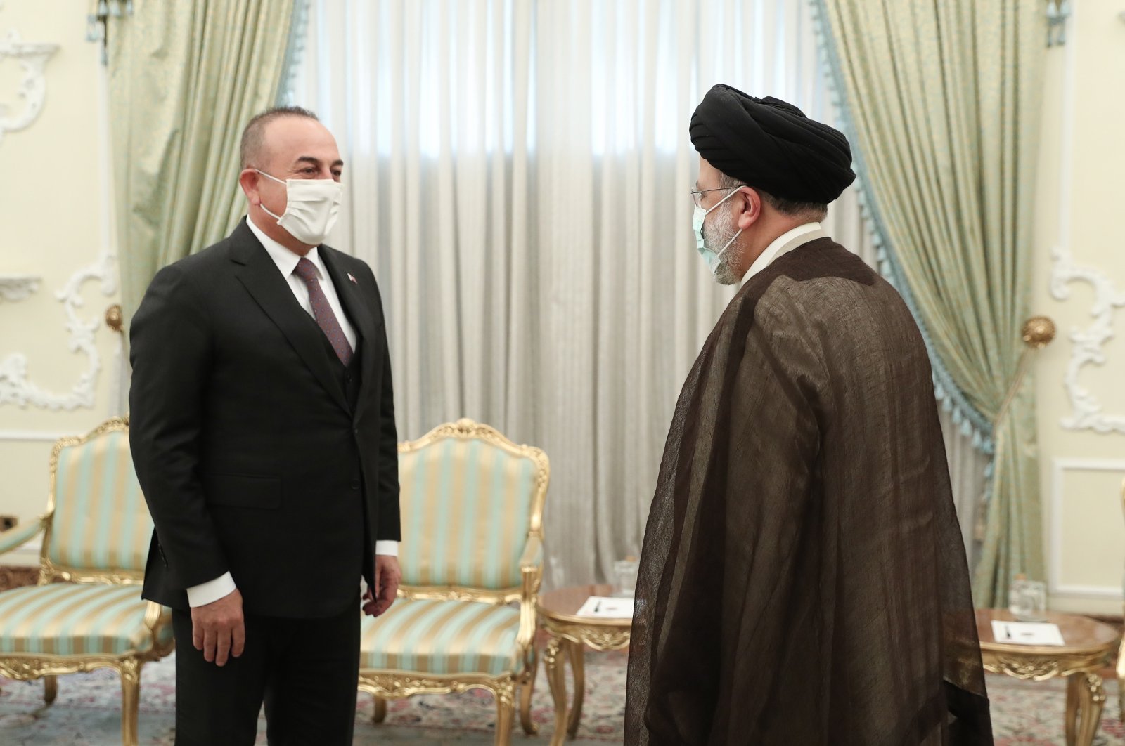 Foreign Minister Mevlüt Çavuşoğlu (L) is greeted by Iranian President Ebrahim Raisi in Tehran, Iran, Nov. 15, 2021. (EPA Photo)