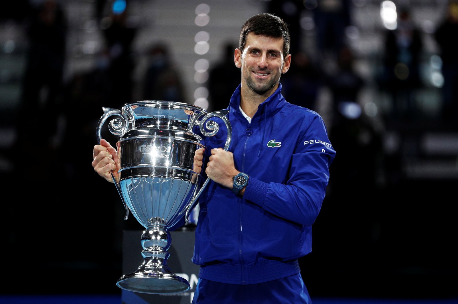 Serbia&#039;s Novak Djokovic poses as he celebrates with the trophy for his 2021 world number one ranking after winning his group stage match against Norway&#039;s Casper Ruud at the ATP Finals in Turin, Italy, Nov. 15, 2021. (Reuters Photo)