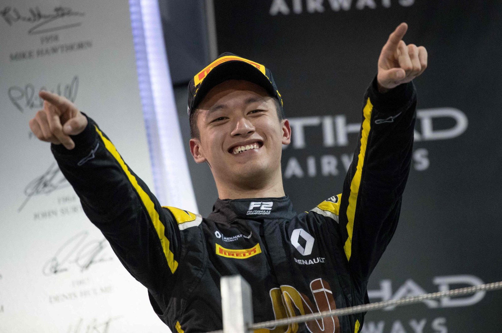 Chinese driver Zhou Guanyu reacting after taking third place at a feature race during the 12th and final round of the 2019 FIA Formula 2 championship at the Yas Marina Circuit in Abu Dhabi, United Arab Emirates (UAE), Nov. 30, 2019. (AFP File Photo)
