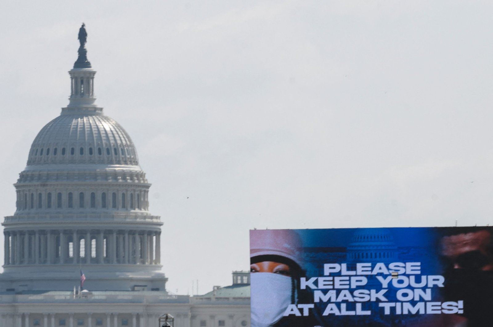 A sign advocating for mask wearing to protect against COVID-19 on the National Mall with the U.S. Capitol in the background is seen in Washington, D.C., Aug. 28, 2021. (AFP File Photo)
