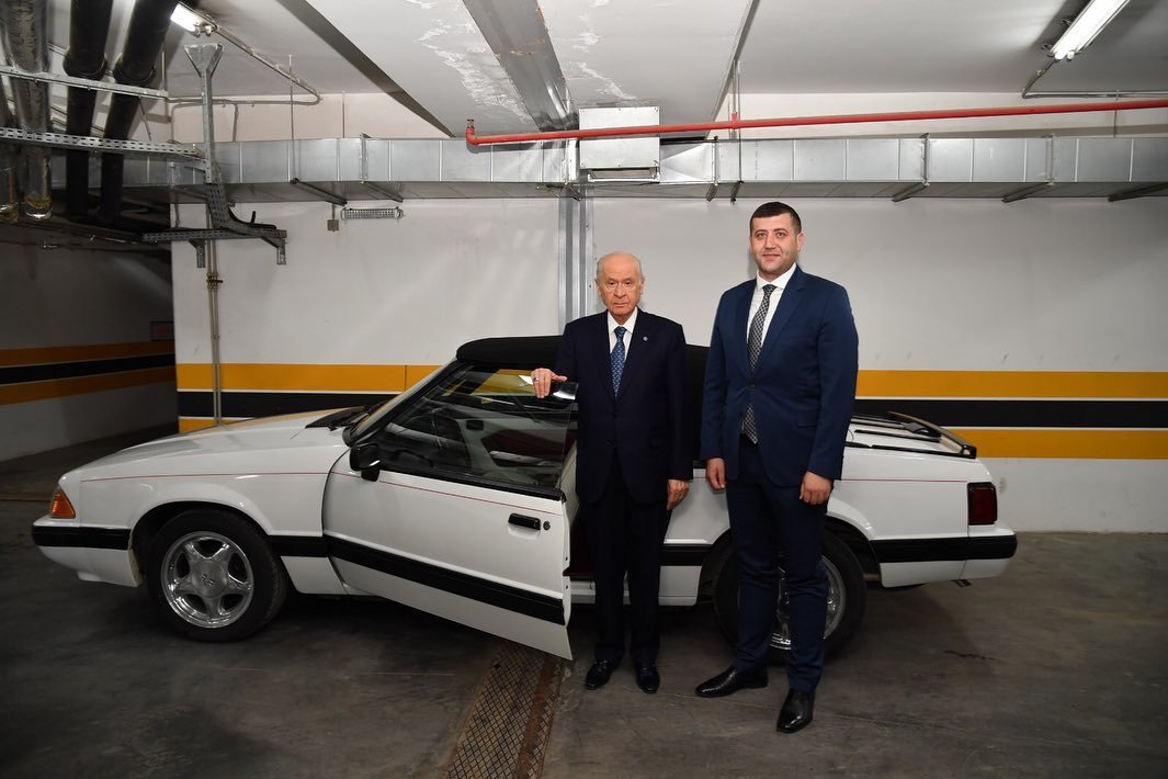 MHP Chairperson Devlet Bahçeli and MHP deputy for Kayseri Baki Ersoy in front of the Ford Mustang that Bahçeli gifted to Ersoy, May 14, 2019 (Sabah Photo)