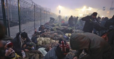 Migrants from the Middle East and elsewhere gather at the checkpoint "Kuznitsa" at the Belarus-Poland border near Grodno, Belarus, Nov. 15, 2021. (AP Photo)