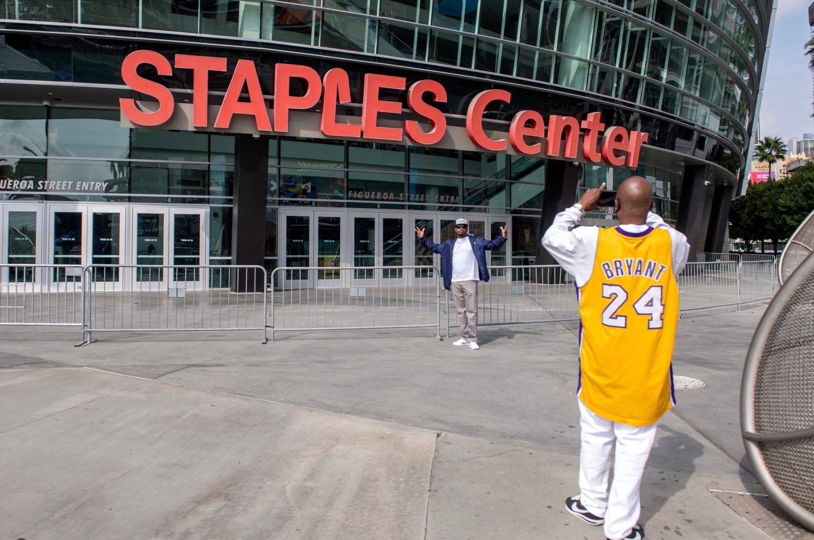 People take photos in front of the Staples Center, in Los Angeles, U.S., March 14, 2021. (AFP Photo)