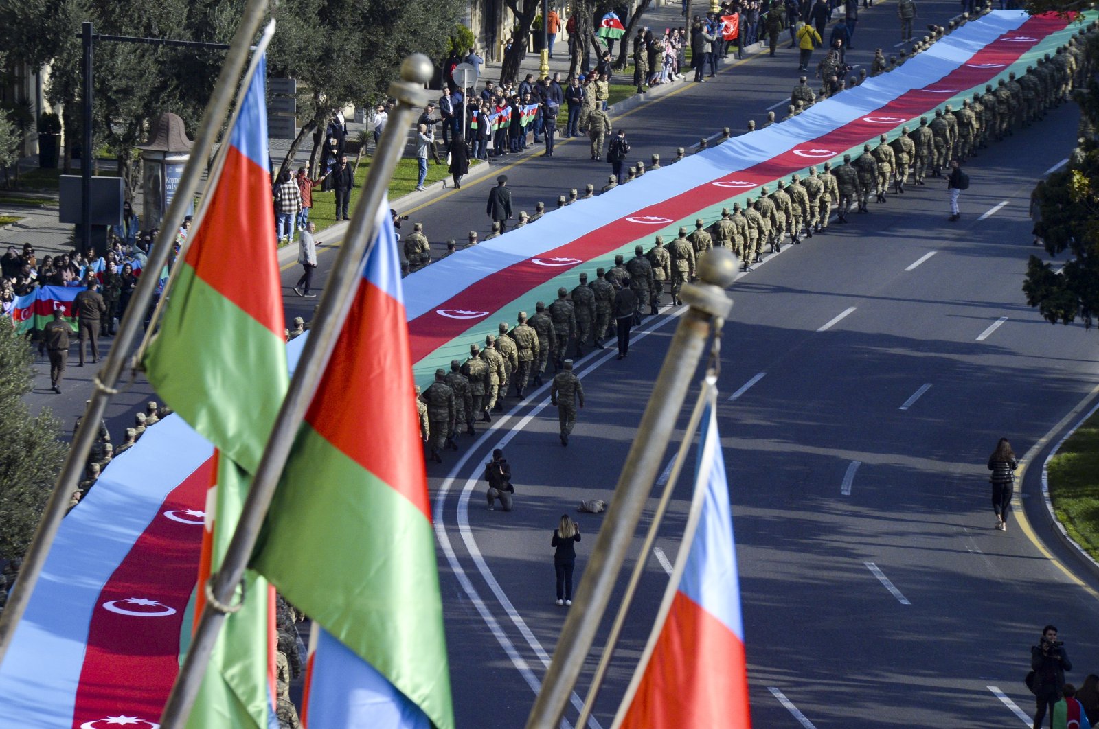 Soldiers carry a 440-meter-long (1,444-foot) Azerbaijan national flag to celebrate the Victory Day in Baku, Azerbaijan, Monday, Nov. 8, 2021. The celebrations mark the one-year anniversary of Azerbaijan's victory in six weeks of heavy fighting over Nagorno-Karabakh. (AP Photo)