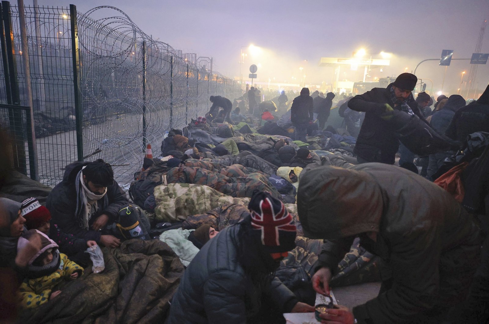 Migrants from the Middle East and elsewhere gather at the checkpoint &quot;Kuznitsa&quot; at the Belarus-Poland border near Grodno, Belarus, Nov. 15, 2021. (AP Photo)