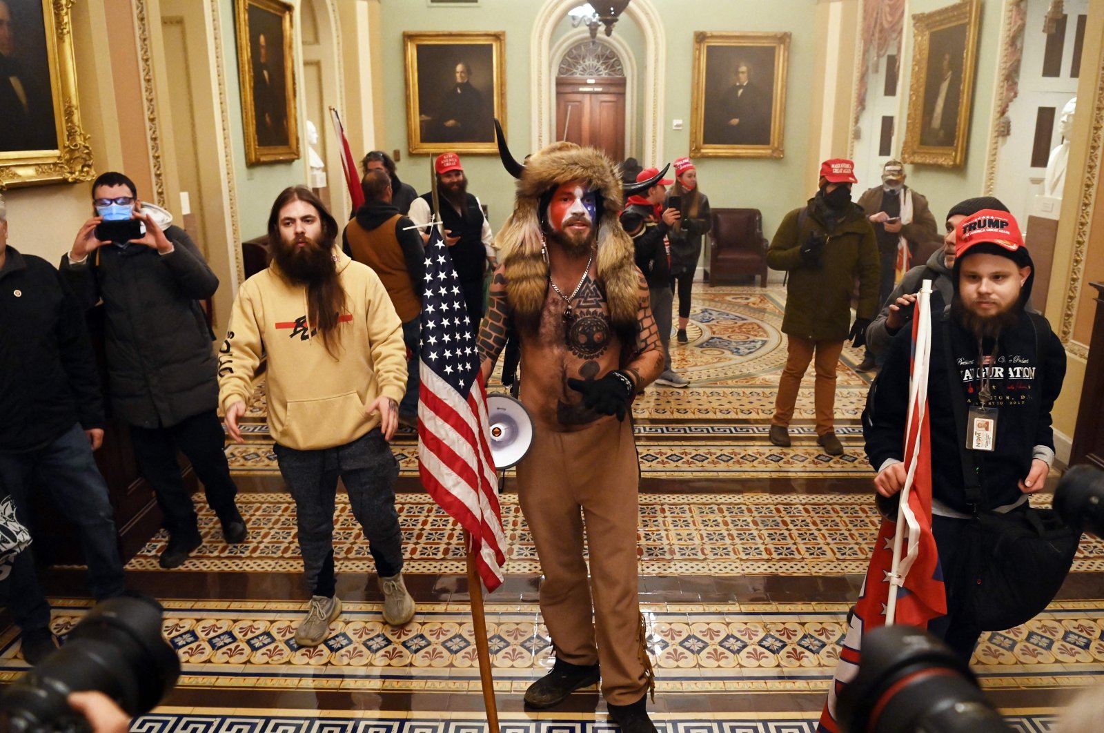 Supporters of U.S. President Donald Trump, including members of the QAnon conspiracy group Jacob Anthony Chansley, aka QAnon Shaman (C), enters the U.S. Capitol in Washington, D.C., Jan. 6, 2021. (AFP Photo)
