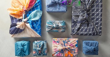 This image provided by Better Homes & Gardens shows fabric-wrapped gifts. (Jacob Fox/Better Homes & Gardens via AP)