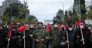 People dressed as soldiers march towards the U.S. Embassy during a rally marking the 48th anniversary of 1973 Athens Polytechnic student uprising, in Athens, Greece, Nov. 17, 2021. (Reuters Photo)