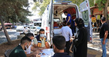 People wait for vaccination outside an ambulance turned into a mobile vaccination point in Şanlıurfa, southeastern Turkey, Sept. 24, 2021. (DHA Photo)