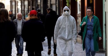 A man wearing a protective suit walks through the Prague city center, as the Czech government shut most shops and restaurants for 10 days as part of measures to contain the spread of the new coronavirus disease, Czech Republic, March 14, 2020. (Reuters Photo)