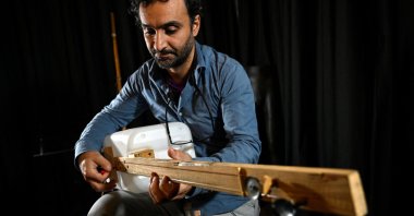 Fungistanbul band member Roni Aran plays one of his instruments made with waste in Istanbul, Turkey, Nov. 8, 2021. (AFP Photo)