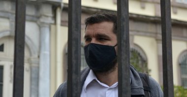 Greek Nasos Karakitsos stands at the yard of a court before his trial in Mytilene port, on the northeastern Aegean island of Lesbos, Greece, Nov. 18, 2021. (AP Photo)