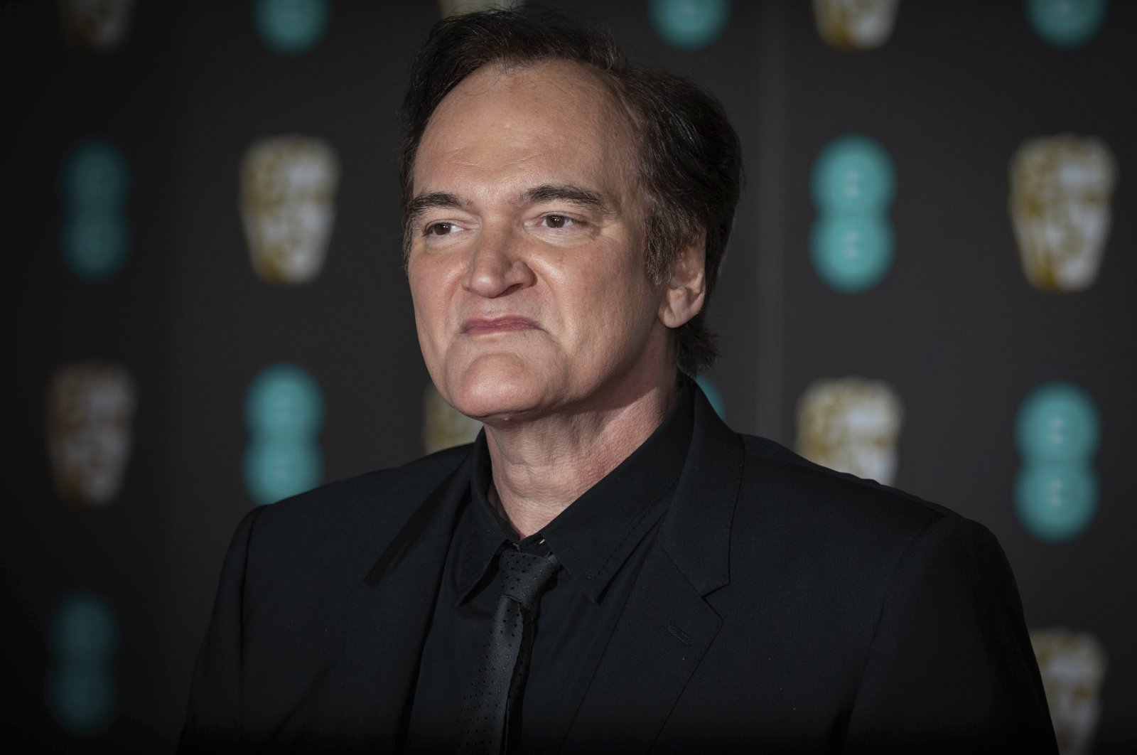 Director Quentin Tarantino poses for photographers arriving at the Bafta Film Awards, in central London, U.K., Feb. 2, 2020. (AP)