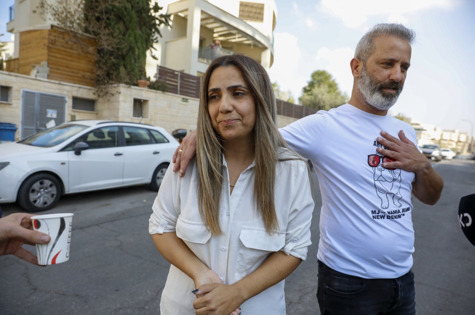 Mordi and Natalie Oknin speak to journalists outside their home, in Modiin, Israel, Nov. 18, 2021. (AP Photo)