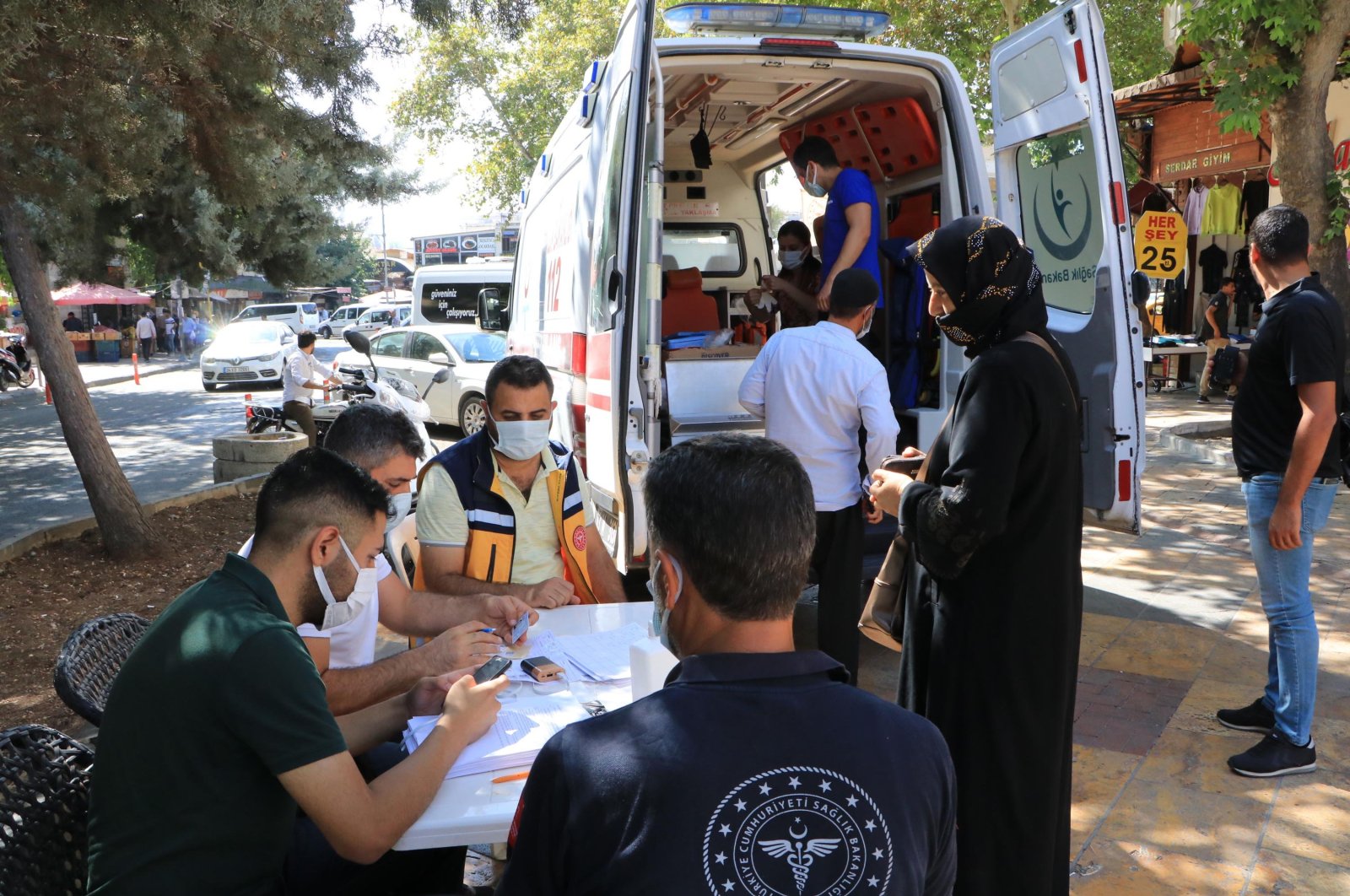 People wait for vaccination outside an ambulance turned into a mobile vaccination point in Şanlıurfa, southeastern Turkey, Sept. 24, 2021. (DHA Photo)