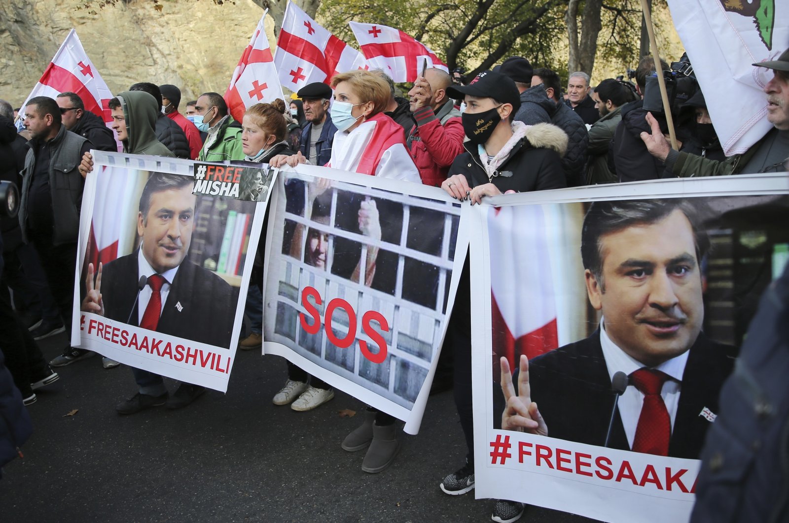 Georgian opposition protestors with its national flag and posters of ex-President Mikheil Saakashvili rally in his support in Tbilisi, Georgia, Nov. 15, 2021. (AP Photo)
