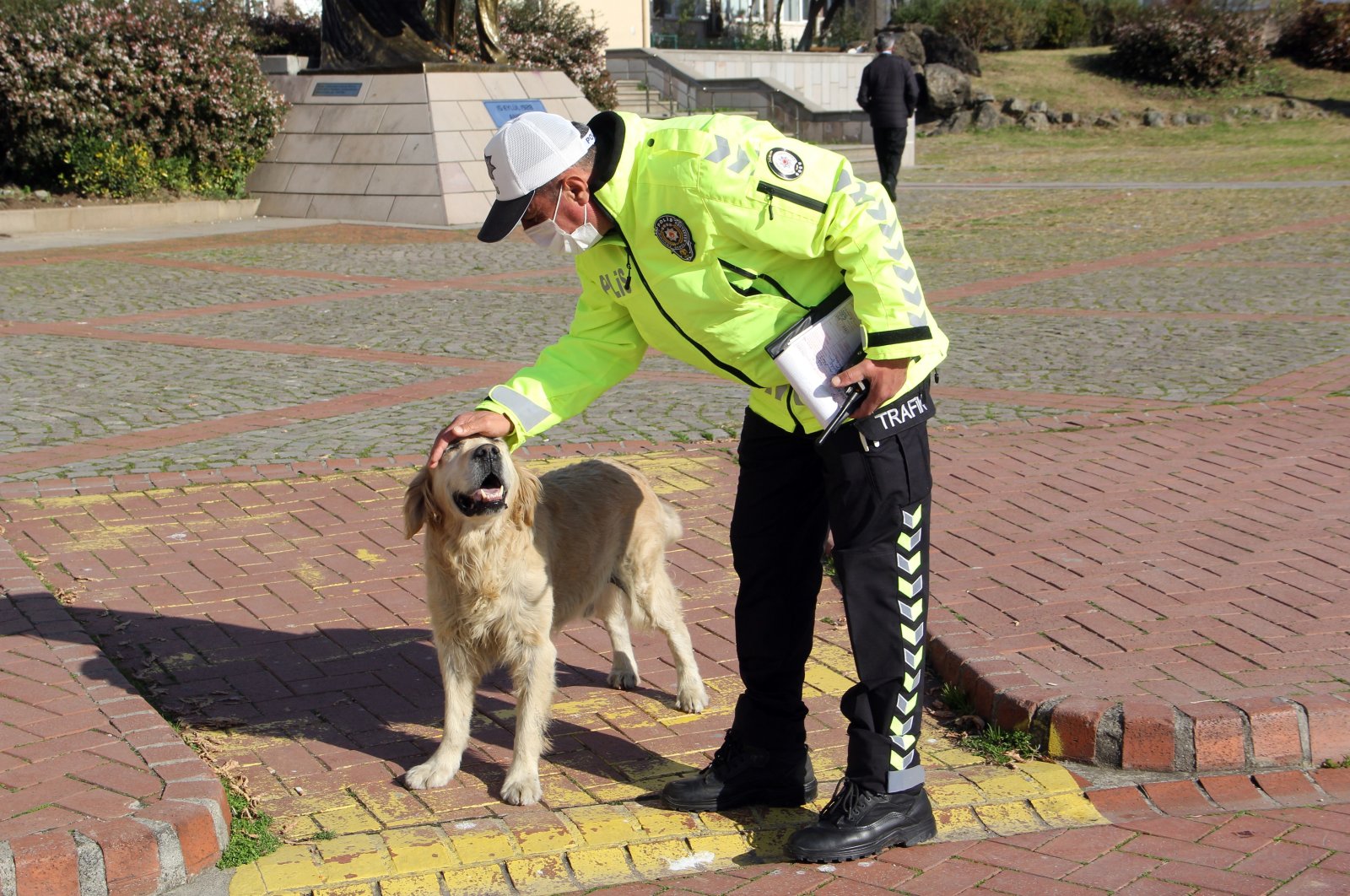 Halis Arslan pets stray dog Köpük, in Sinop, northern Turkey, Nov. 18, 2021. (AA Photo)