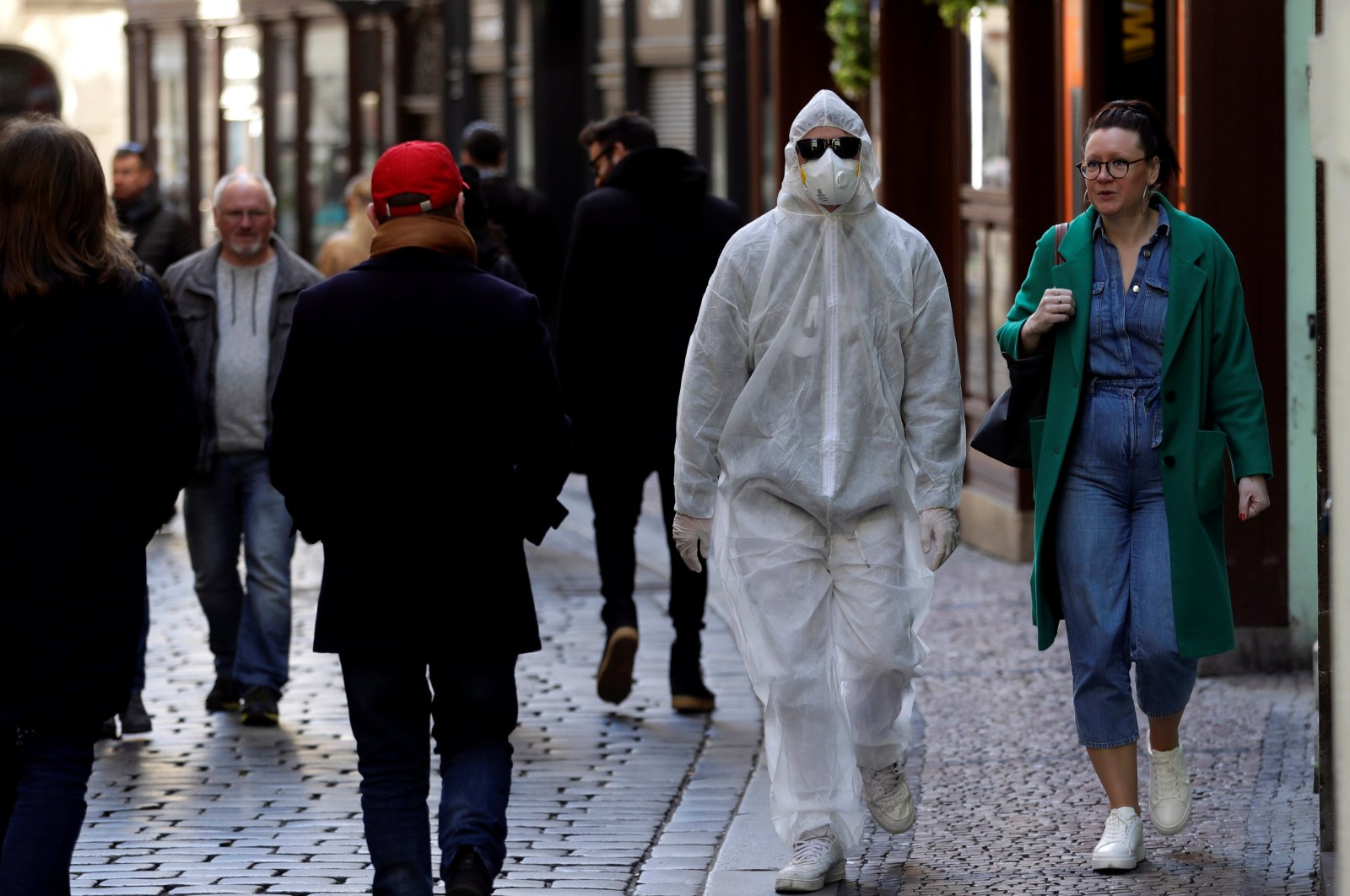 A man wearing a protective suit walks through the Prague city center, as the Czech government shut most shops and restaurants for 10 days as part of measures to contain the spread of the new coronavirus disease, Czech Republic, March 14, 2020. (Reuters Photo)