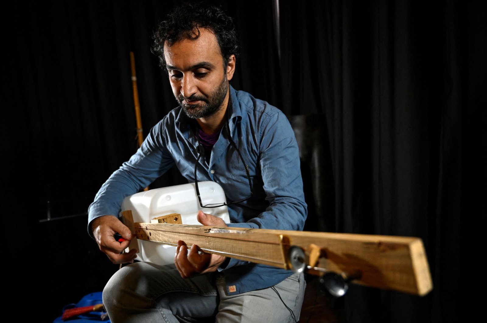 Fungistanbul band member Roni Aran plays one of his instruments made with waste in Istanbul, Turkey, Nov. 8, 2021. (AFP Photo)