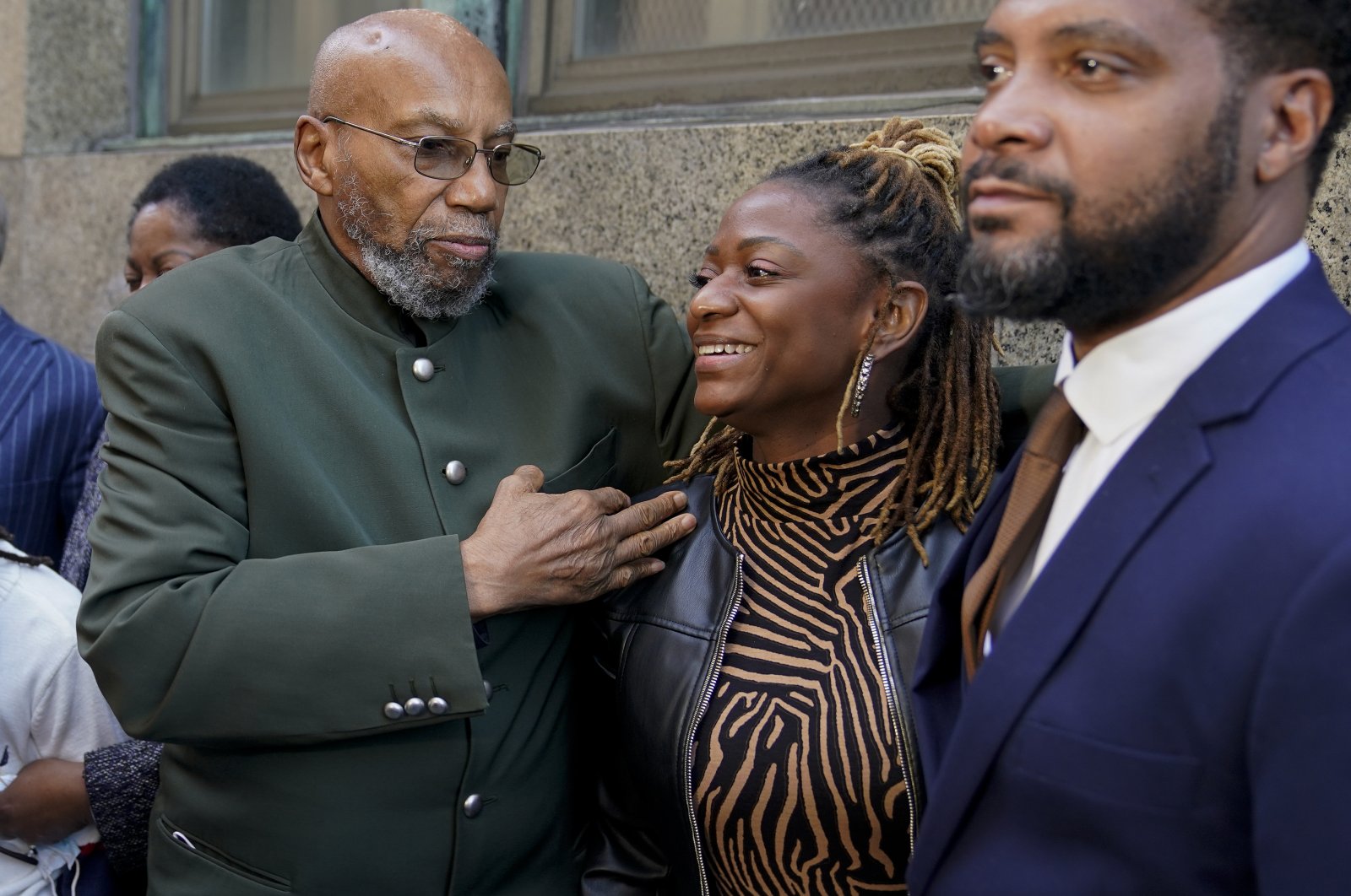 Muhammad Aziz, left, stands outside the courthouse with members of his family after his conviction in the killing of Malcolm X was vacated, Thursday, Nov. 18, 2021, in New York. (AP Photo)