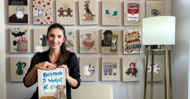 Dilek Yalçın poses with some of her paintings from “Innocence of Objects."