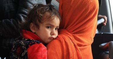 Refugees board buses that take them to a processing center after they arrive at Dulles International Airport after being evacuated from Kabul following the Taliban takeover of Afghanistan, in Dulles, Virginia, Aug. 27, 2021. (AFP Photo)
