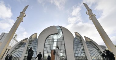 People stand outside the central mosque on the "Day of Open Mosques" in Cologne, Germany, Oct. 3, 2017. (AP File Photo)