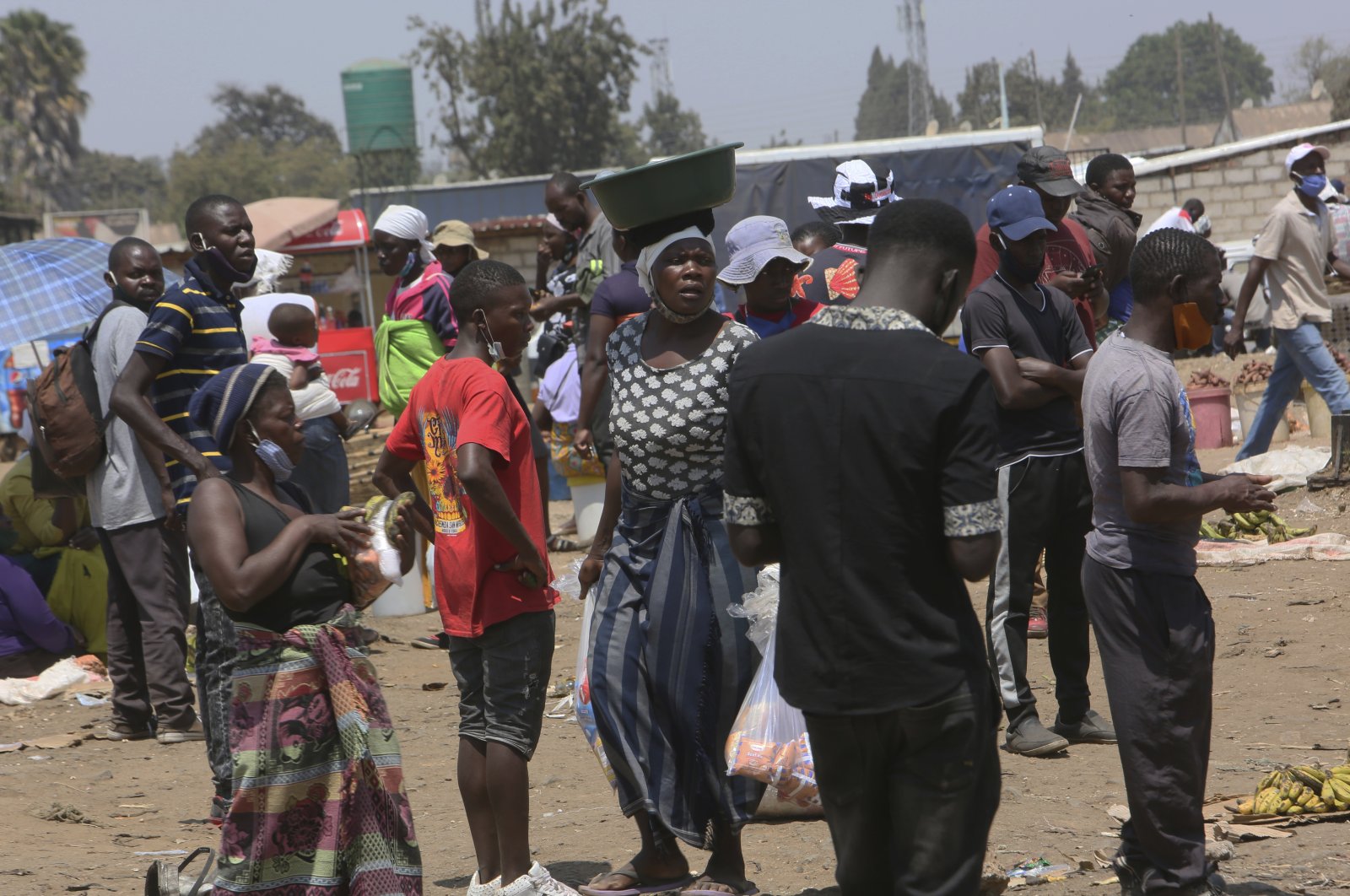 People are seen at a busy market in a poor township on the outskirts of the capital Harare, Zimbabwe, Nov. 15, 2021. (AP Photo)