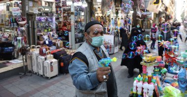 Iranians walk down a market street in Tehran, Iran, Nov. 14, 2021. (WANA (West Asia News Agency) via Reuters)