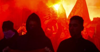 Demonstrators light flares during a demonstration against measures to battle the coronavirus pandemic in Vienna, Austria, Nov. 20, 2021. (AP Photo)