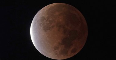 The earth&#039;s shadow covers the full moon during a partial lunar eclipse, as seen from Kansas City, Missouri, U.S., Nov. 19, 2021. (AP Photo)