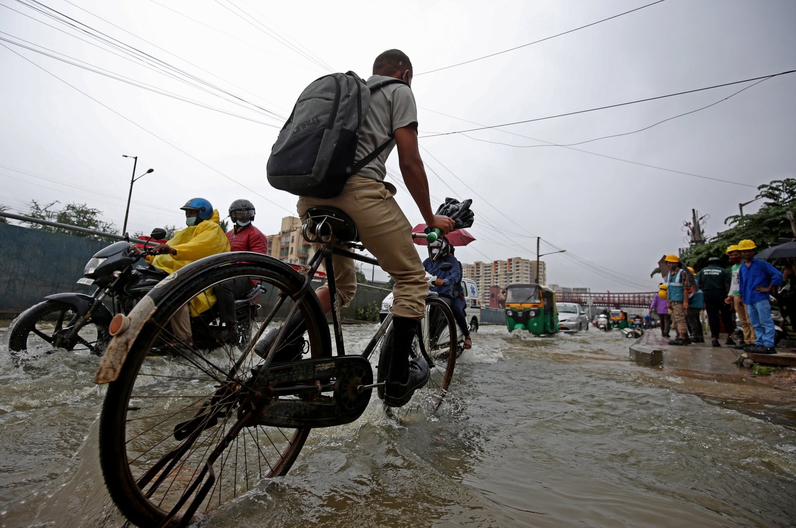 People make their way through a flooded street following heavy rainfalls in Bangalore, India, Nov. 19, 2021. (EPA Photo) 