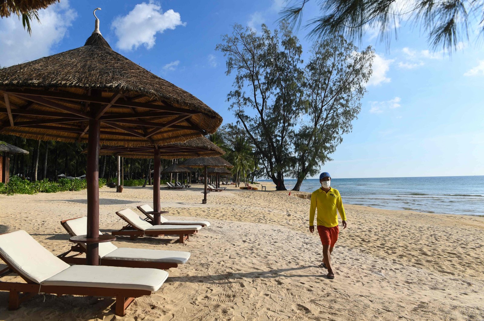 A lifeguard walks along the beach in the Vinpearl leisure complex as the island prepares for its first international tourists to arrive after a COVID-19 vaccine passport scheme kicked off this month, Phu Quoc, Vietnam, Nov. 19, 2021. (AFP Photo)