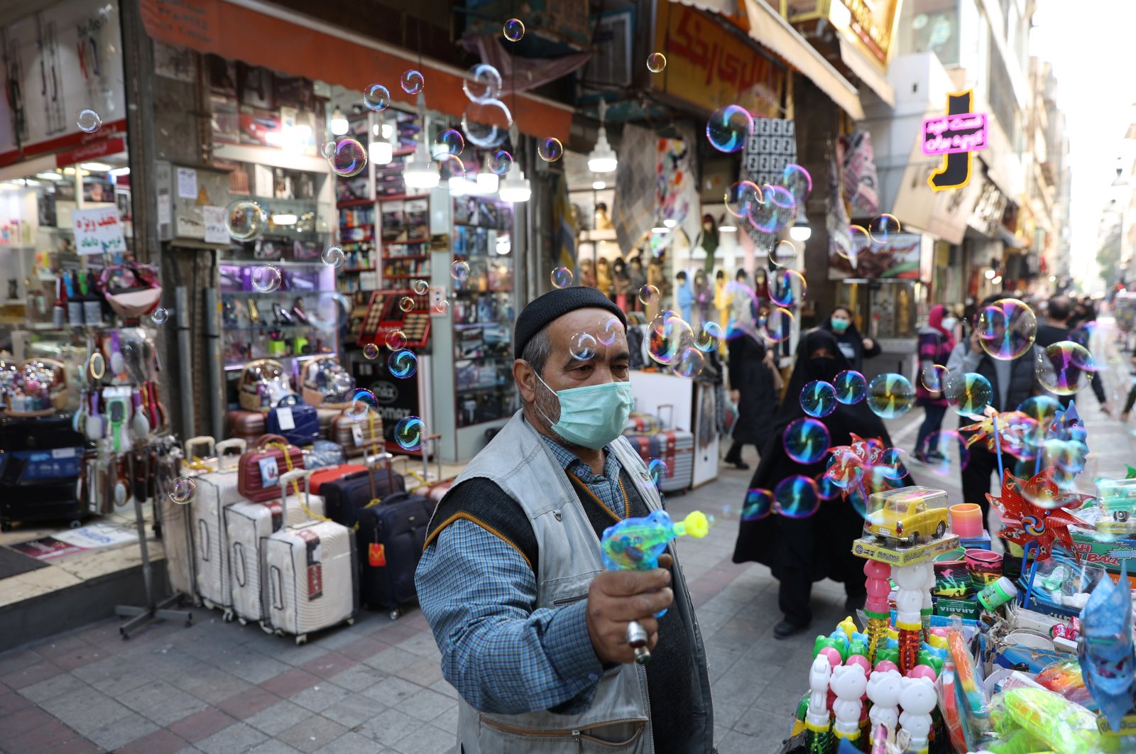 Iranians walk down a market street in Tehran, Iran, Nov. 14, 2021. (WANA (West Asia News Agency) via Reuters)