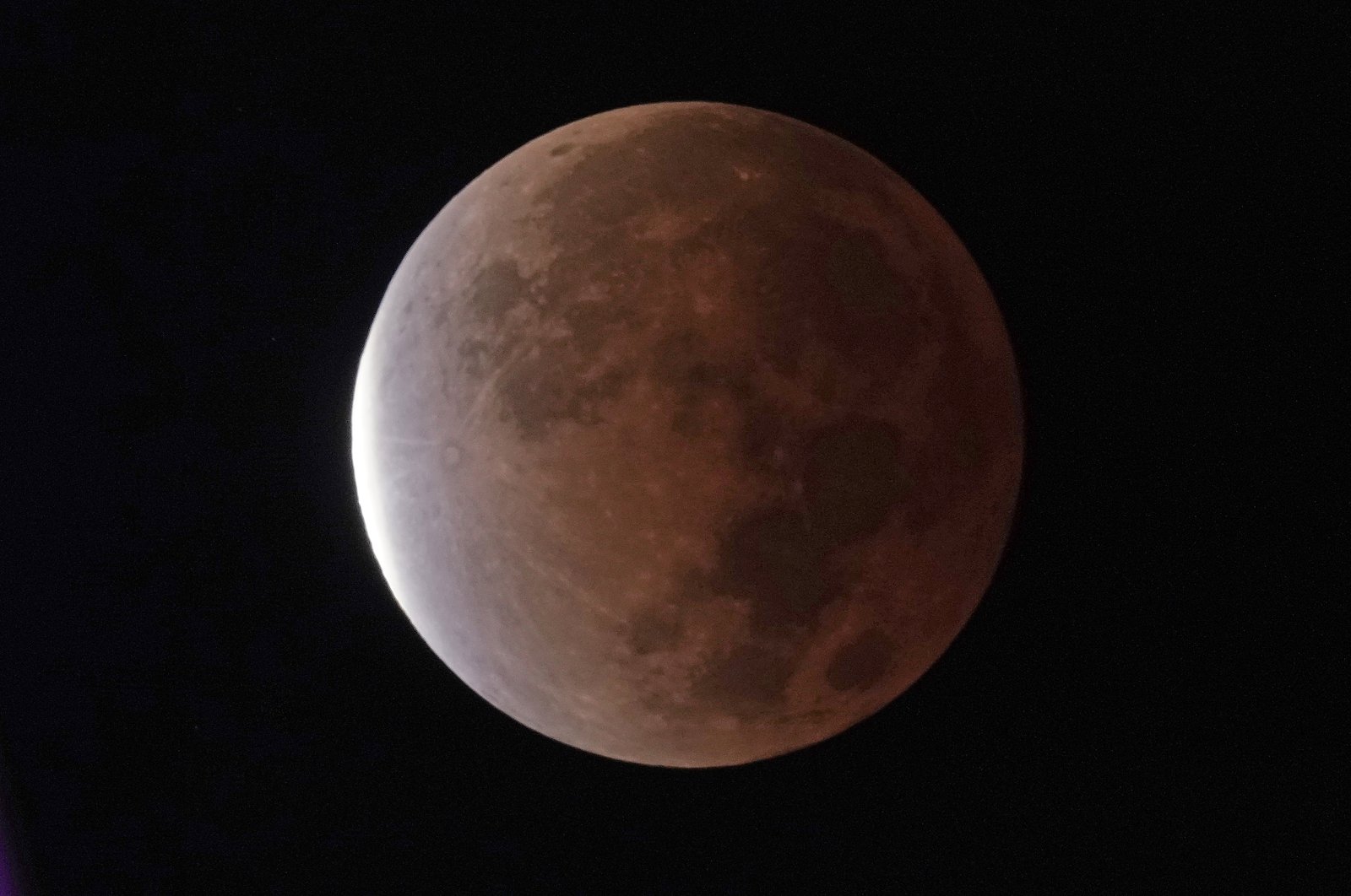 The earth&#039;s shadow covers the full moon during a partial lunar eclipse, as seen from Kansas City, Missouri, U.S., Nov. 19, 2021. (AP Photo)