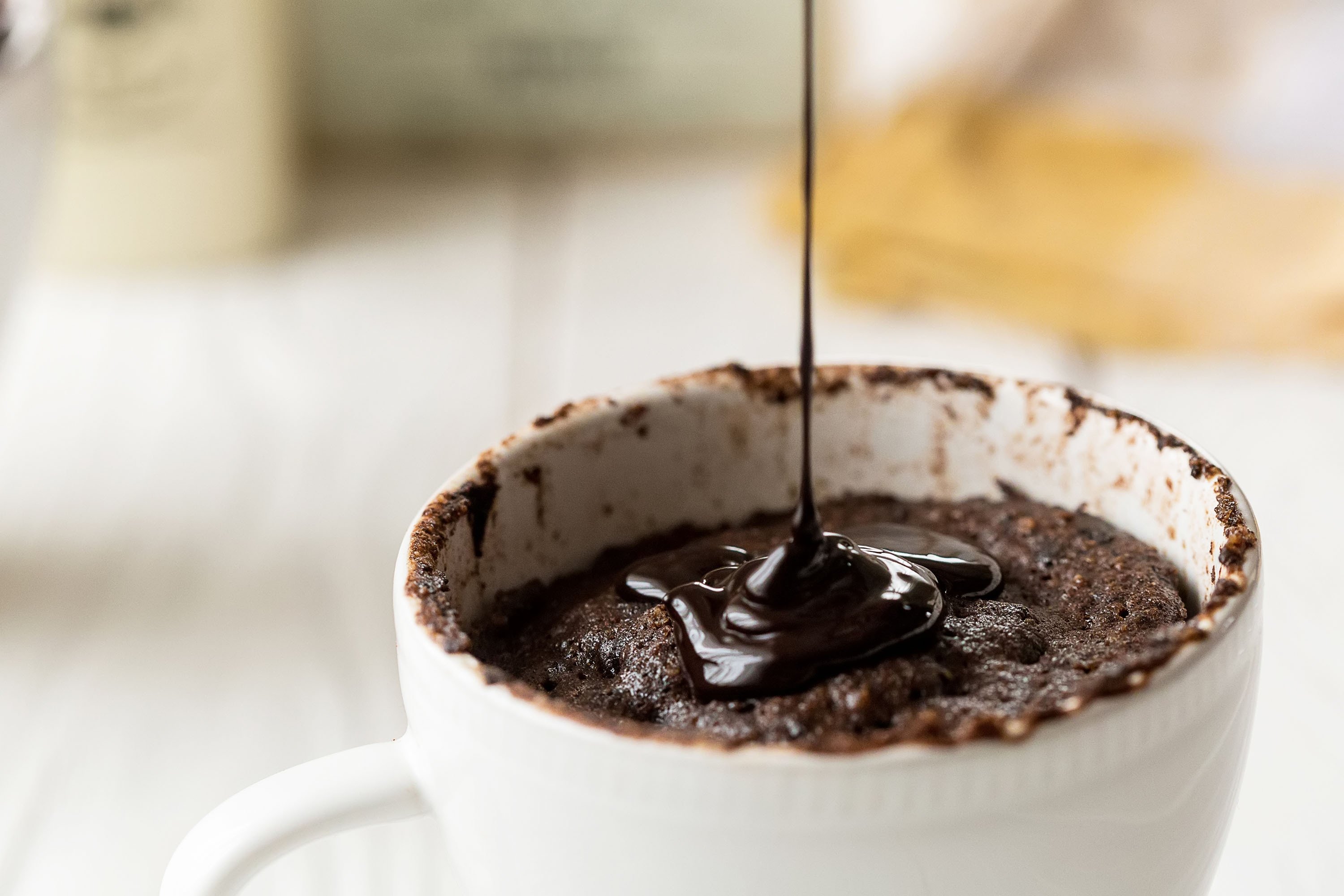 Don't forget to pour some extra chocolate sauce on top of the homemade chocolate brownie mugs. (Shutterstock Photo)