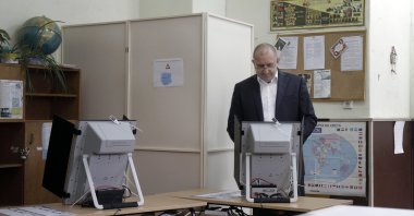 Bulgarian President Rumen Radev votes on a machine at a polling booth in Sofia, Bulgaria, Nov. 21, 2021. (AP Photo)