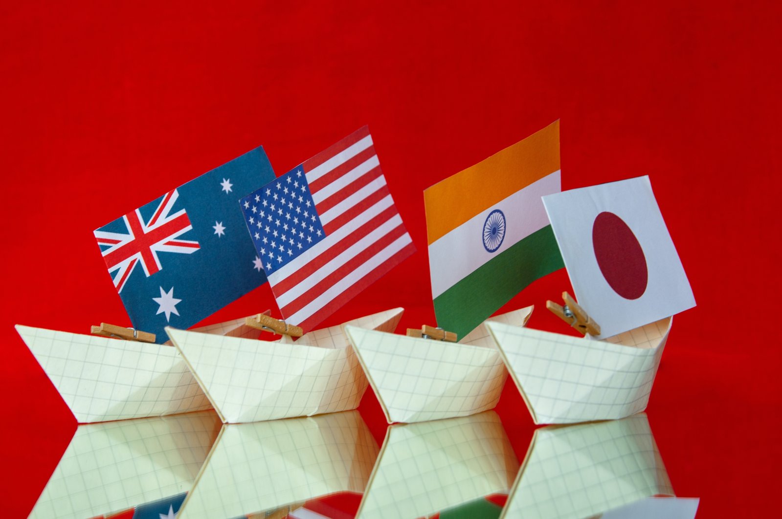 The flags of Australia, the United States, Japan and India are pictured in a reference to the new military alliance and security pact between the countries, called the Quad. (Photo by Shutterstock)