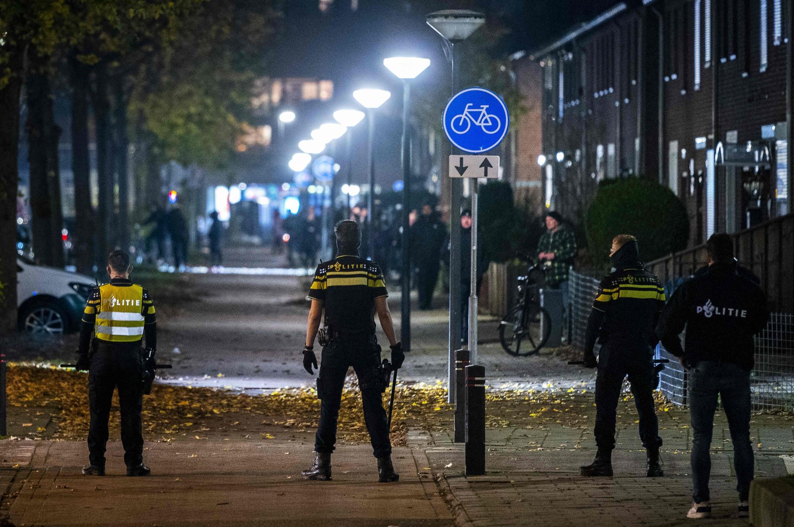 Police officers patrol on the street during riots against the partial lockdown and the 2G government policy at the De Kemp district in Roermond, the Netherlands, on Nov. 20, 2021. (Photo by ROB ENGELAAR / ANP / AFP)