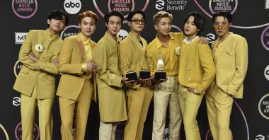BTS poses in the press room with the awards for favorite pop duo or group, favorite pop song for &quot;Butter,” and artist of the year at the American Music Awards on at Microsoft Theater in Los Angeles, U.S., Nov. 21, 2021. (AP)